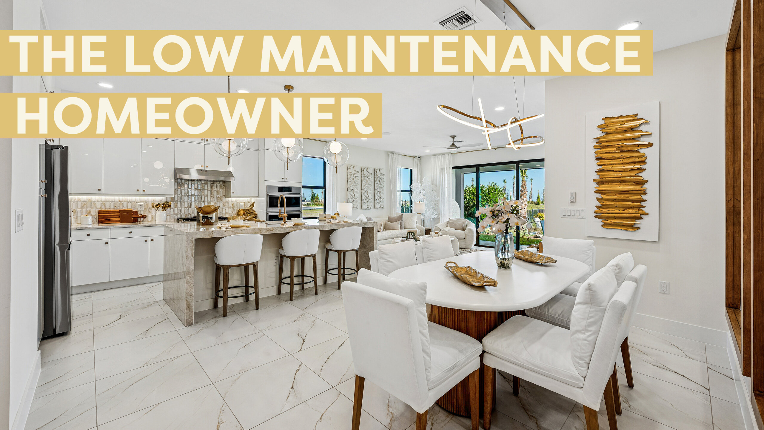 Bright, modern open-plan kitchen and dining area with white cabinetry, marble flooring, and large windows—perfect for the low maintenance homeowner at Catalina Palms. Text overlay reads "THE LOW MAINTENANCE HOMEOWNER.