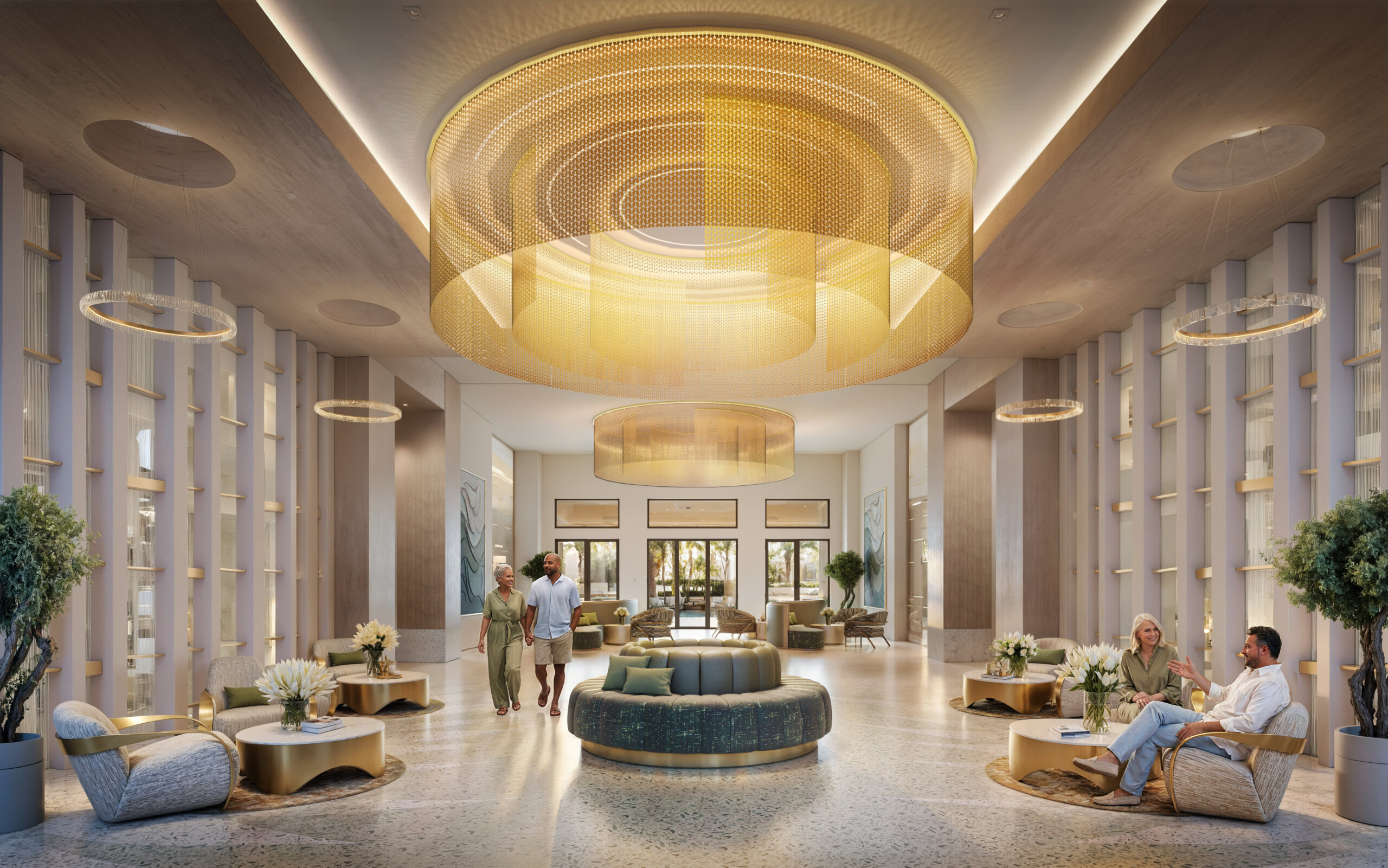 Spacious modern hotel lobby at Club Catalina, featuring large circular golden light fixtures, lounge seating, lush plants, and people relaxing or walking through.